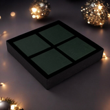 Black rectangular box with grid pattern on a dark background with decorative lights