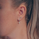 Celestial pair of white gold star huggie hoop earrings - Helix & Conch