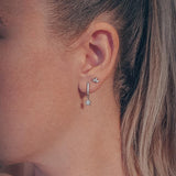 Celestial pair of white gold star huggie hoop earrings - Helix & Conch