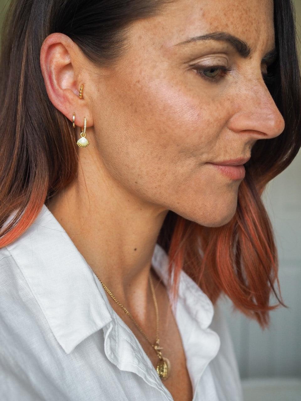 Cascara pair of gold huggie hoop earrings with detachable shell charm - Helix & Conch