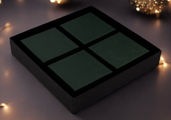 Black rectangular box with grid pattern on a dark background with decorative lights