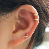 Gold Bow earring and gold internally threaded stud earring