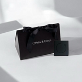 Black gift bag with a bow and 'Helix & Conch' branding on a white background
