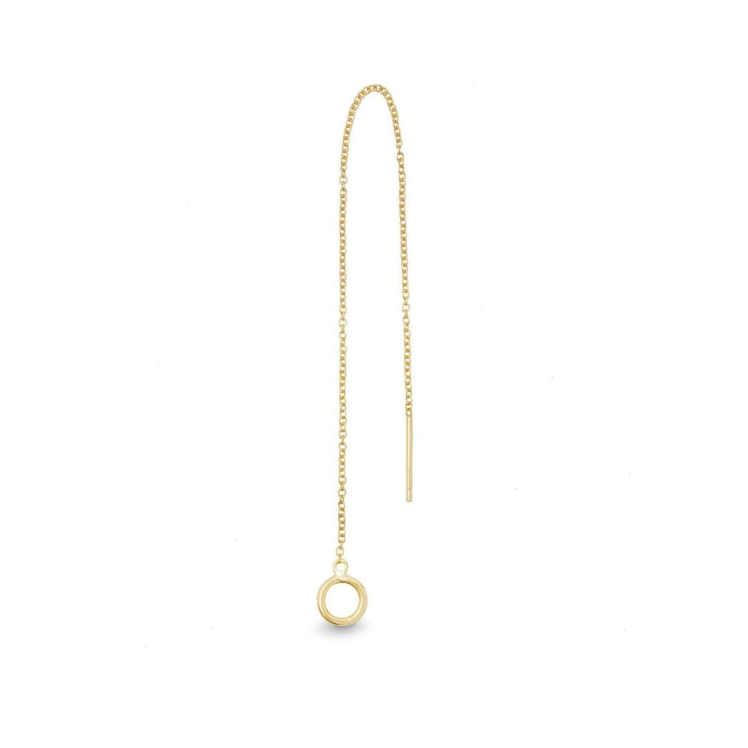 A single yellow gold threader earring with a small circular charm, hanging from a gold-plated chain.