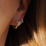 Tilde yellow gold wavy crystal hoop pair of huggie hoop earrings