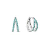 A double hoop earring with turquoise stones on a white gold plated surface, designed to give the illusion of two separate piercings.