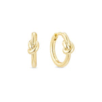A pair of yellow gold knot huggie hoop earrings with a 14k gold plated finish on sterling silver.