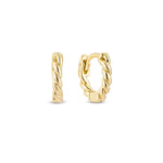 A pair of yellow gold rope huggie hoop earrings on a white background