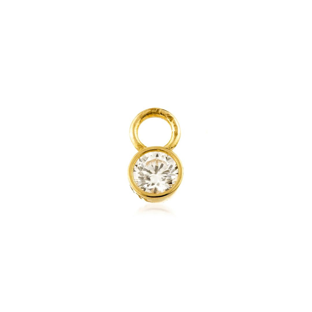 Gold earring charm with a clear gemstone on a white background