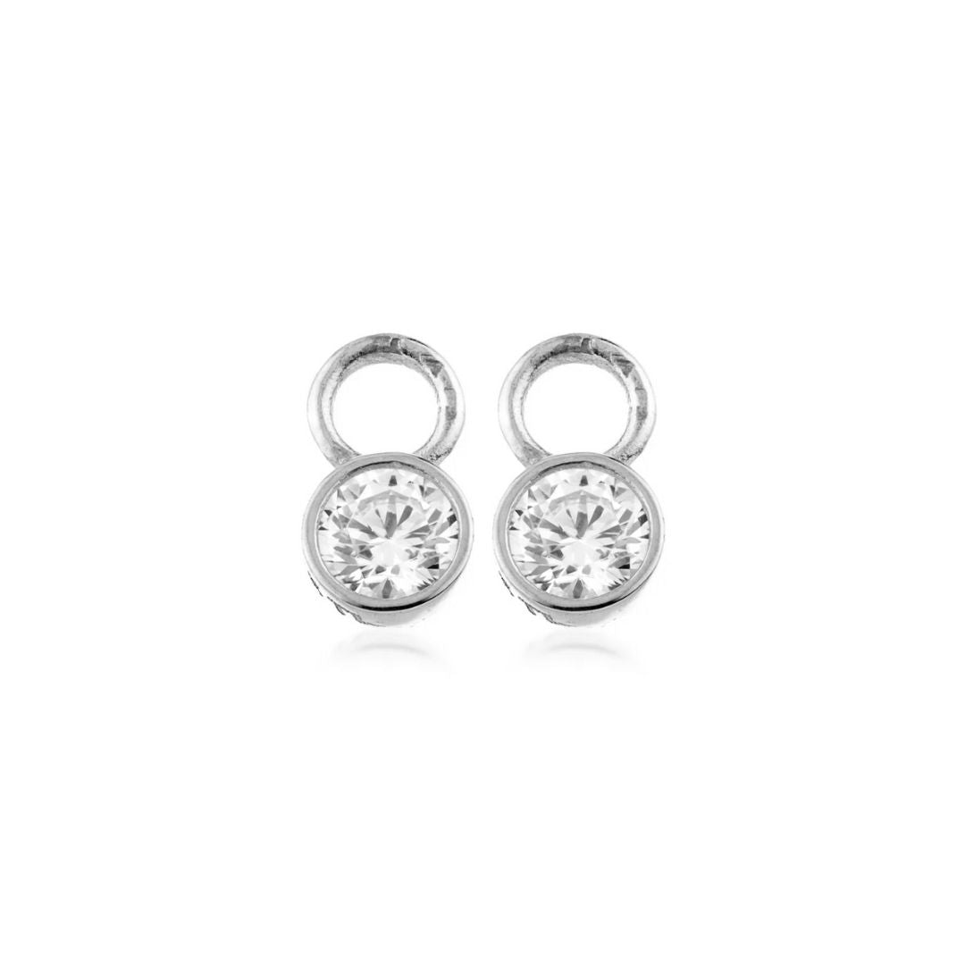 Pair of solid white gold earring charms with clear gemstones on a white background