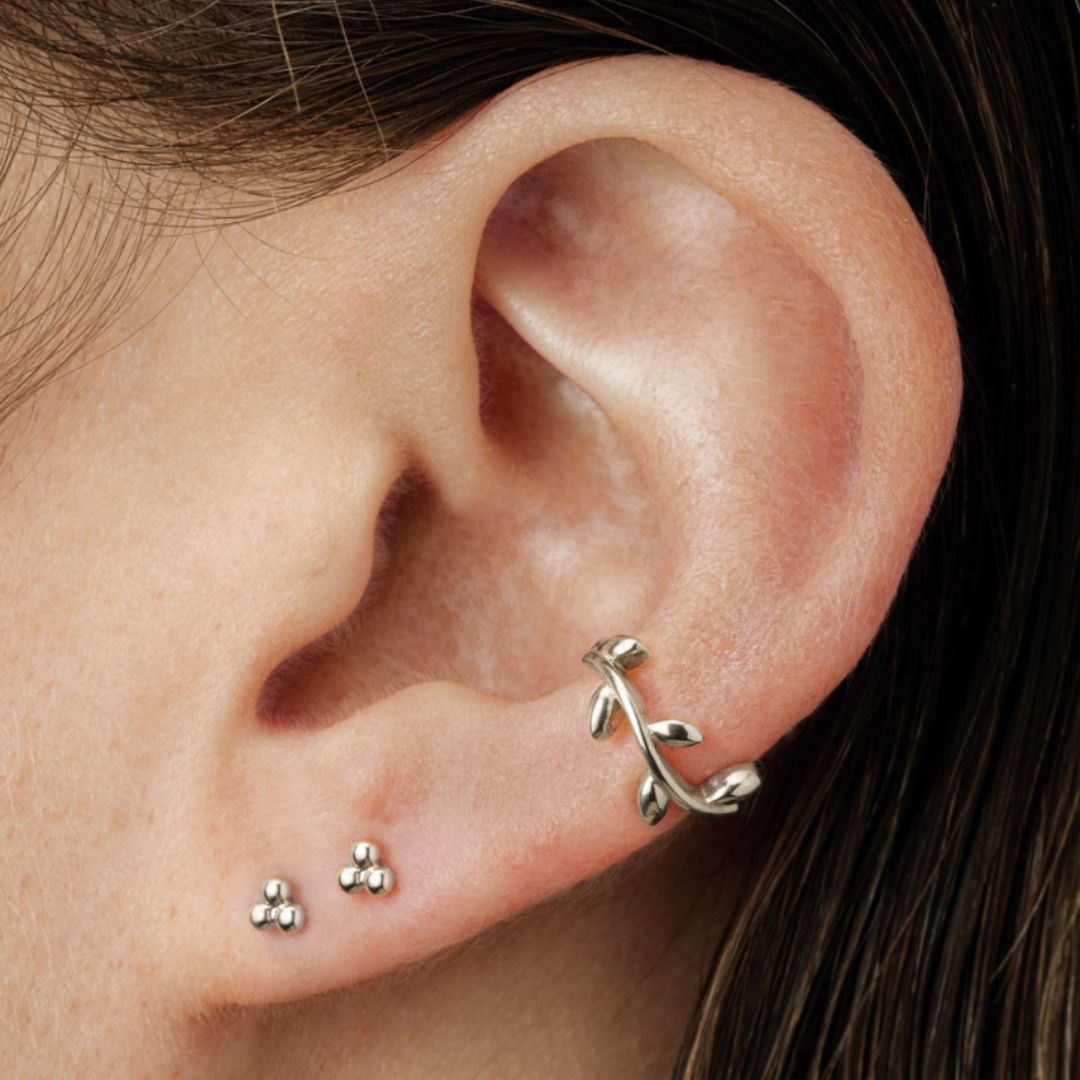 ear with white gold studs and hoop earring