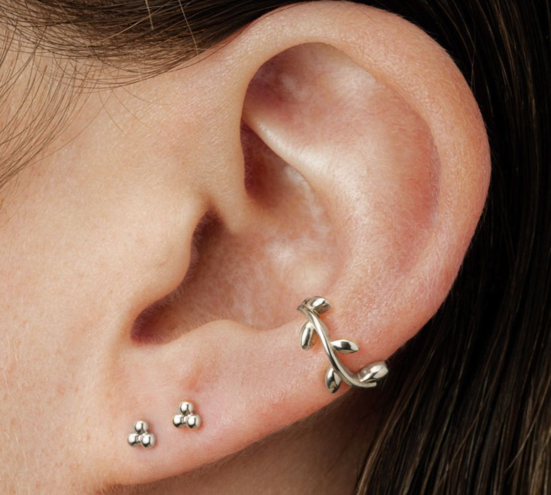 ear with white gold studs and hoop earring