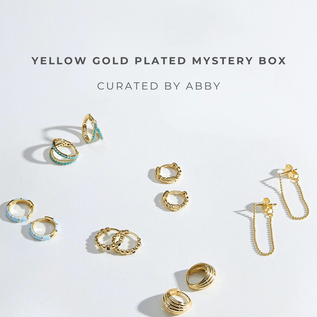 Yellow gold plated earrings on a light gray background with text 'Yellow Gold Plated Mystery Box Curated by Abby'.