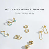 Yellow gold plated earrings on a light gray background with text 'Yellow Gold Plated Mystery Box Curated by Abby'.