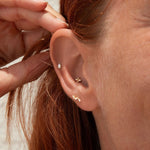 Yellow gold ear stack close up in ear