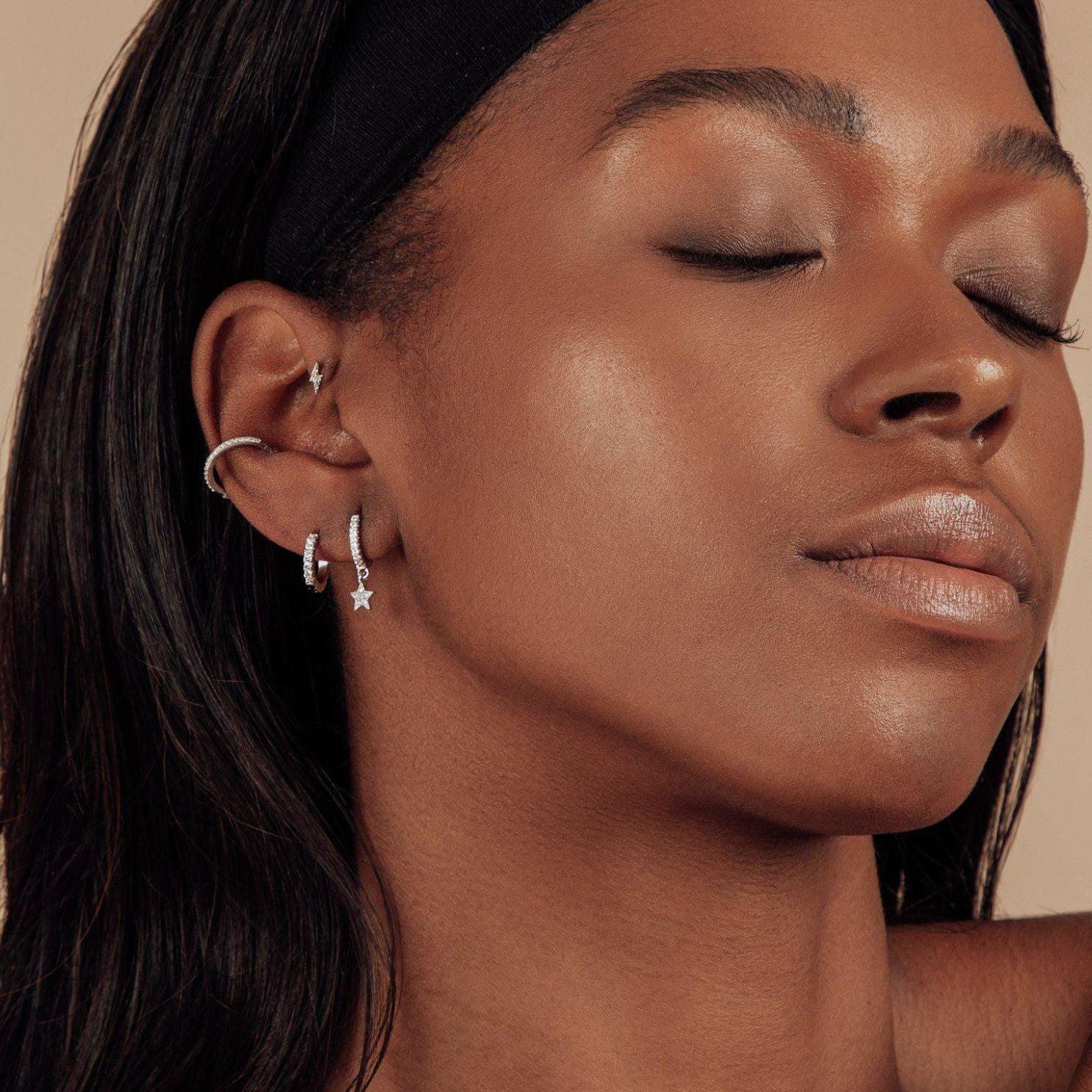 Celestial pair of white gold star huggie hoop earrings - Helix & Conch